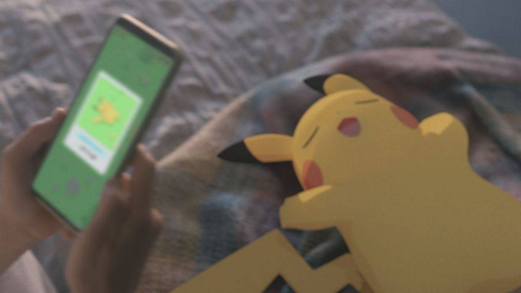 A sleepy Pikachu and a phone displaying the Pokémon Sleep app